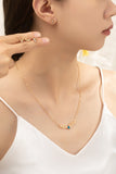 Conjunto de collar con dijes navide–os y 4 pares de tachuelas.