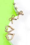Trío de pendientes con dije de corazón y lazo