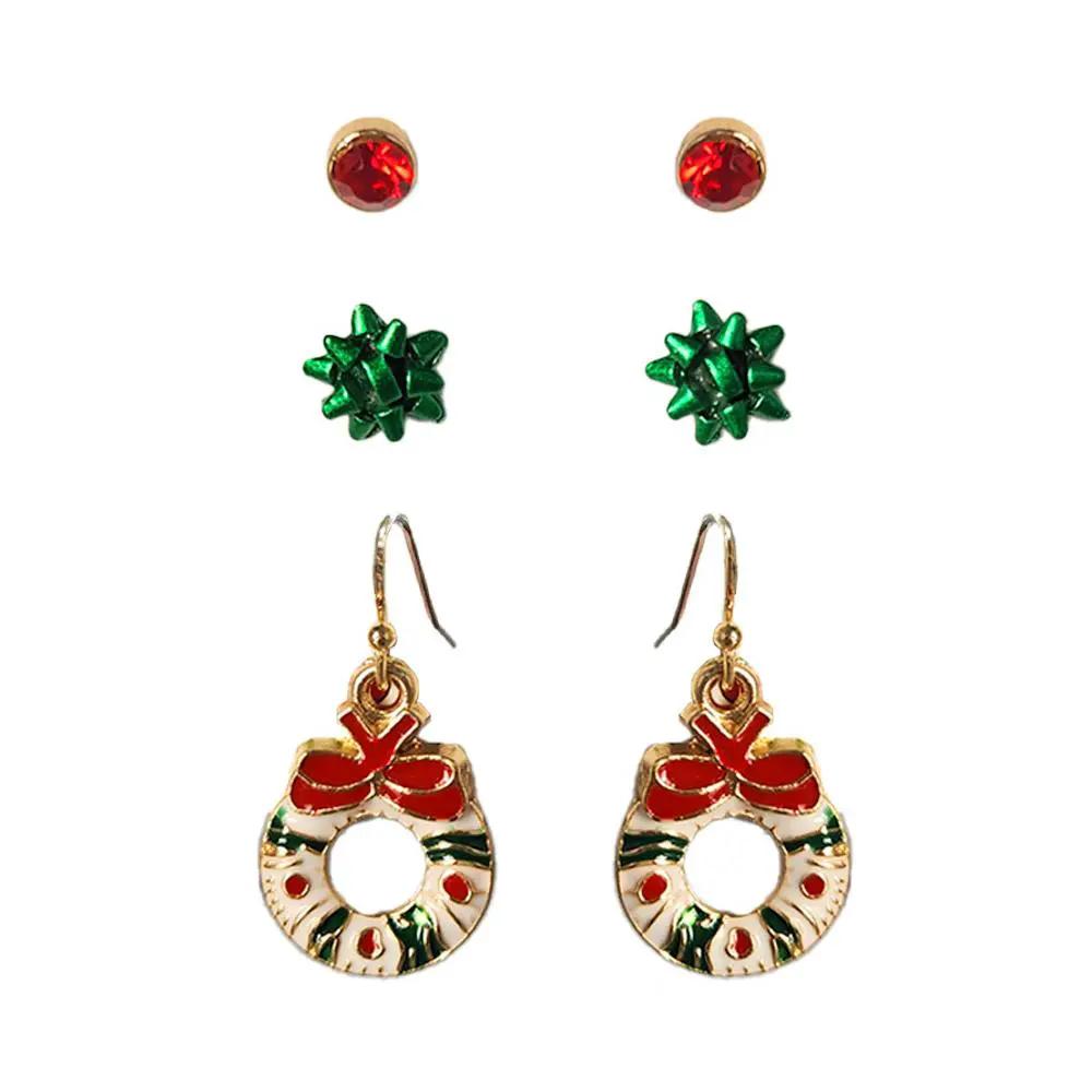 Set de aretes navideños – 3 pares (corona, moñito y cristal rojo) by Yanet Collective