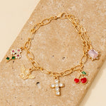 Pulsera de Cadena con Cruz de Querubín y Abalorios de Cereza