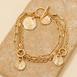 Pulsera con Monedas Texturizadas  de Cadena en Capas