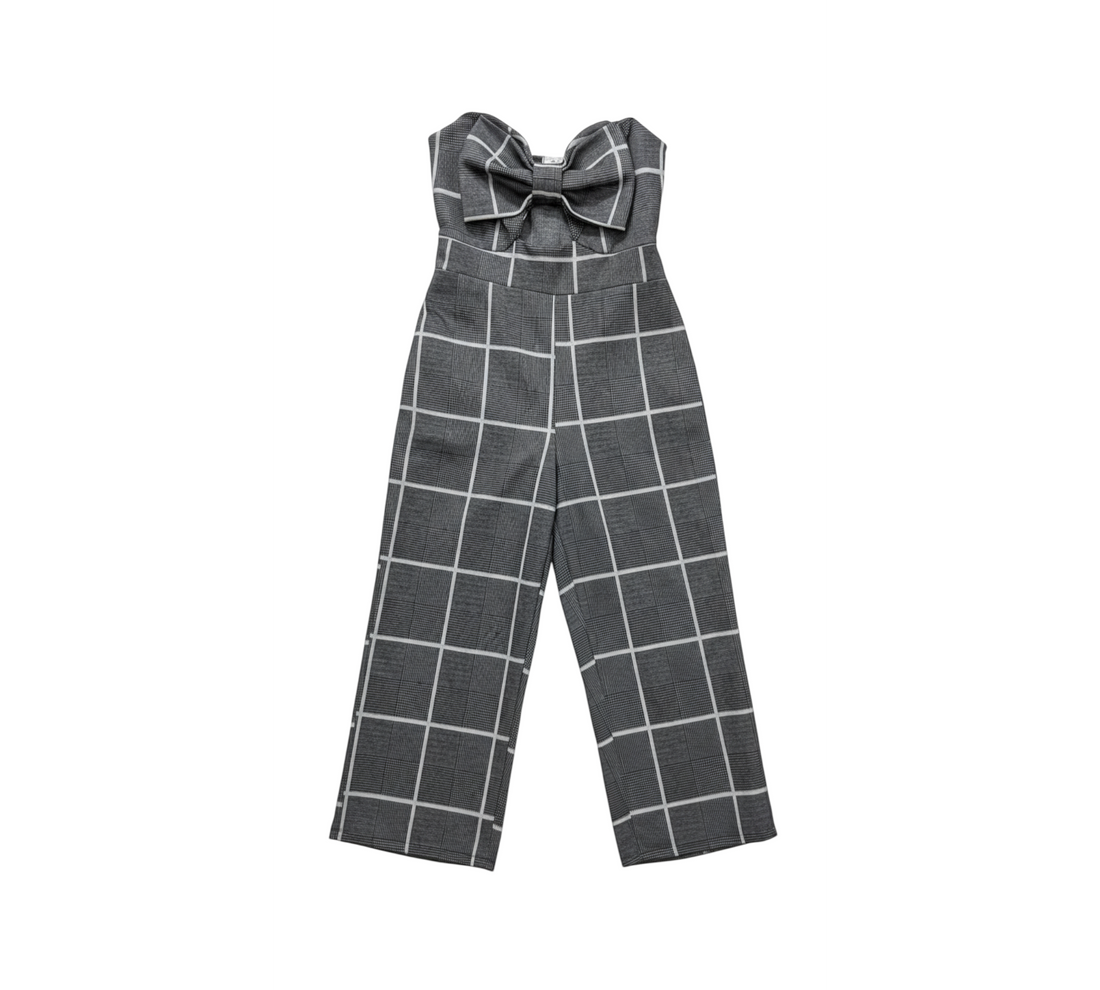 Yanet Collective strapless jumpsuit in black and white plaid with a bow detail on the bodice and wide-leg fit.