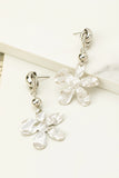 Pendientes colgantes de flores de metal coronados por un nudo , aretes