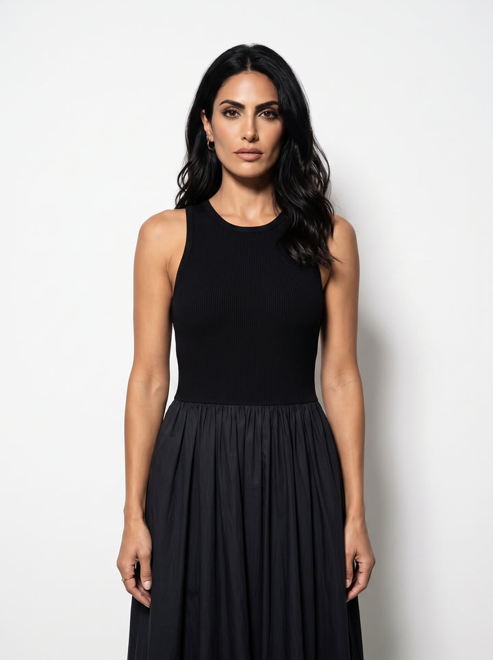 Studio photo of Vestido Negro Maxi Sin Mangas Upper body shot from chest up, facing camera, natural expression, shoulders relaxed. CAMERA SHOT: A FULL BODY shot capturing the person from head to toe. [Upper body focus]