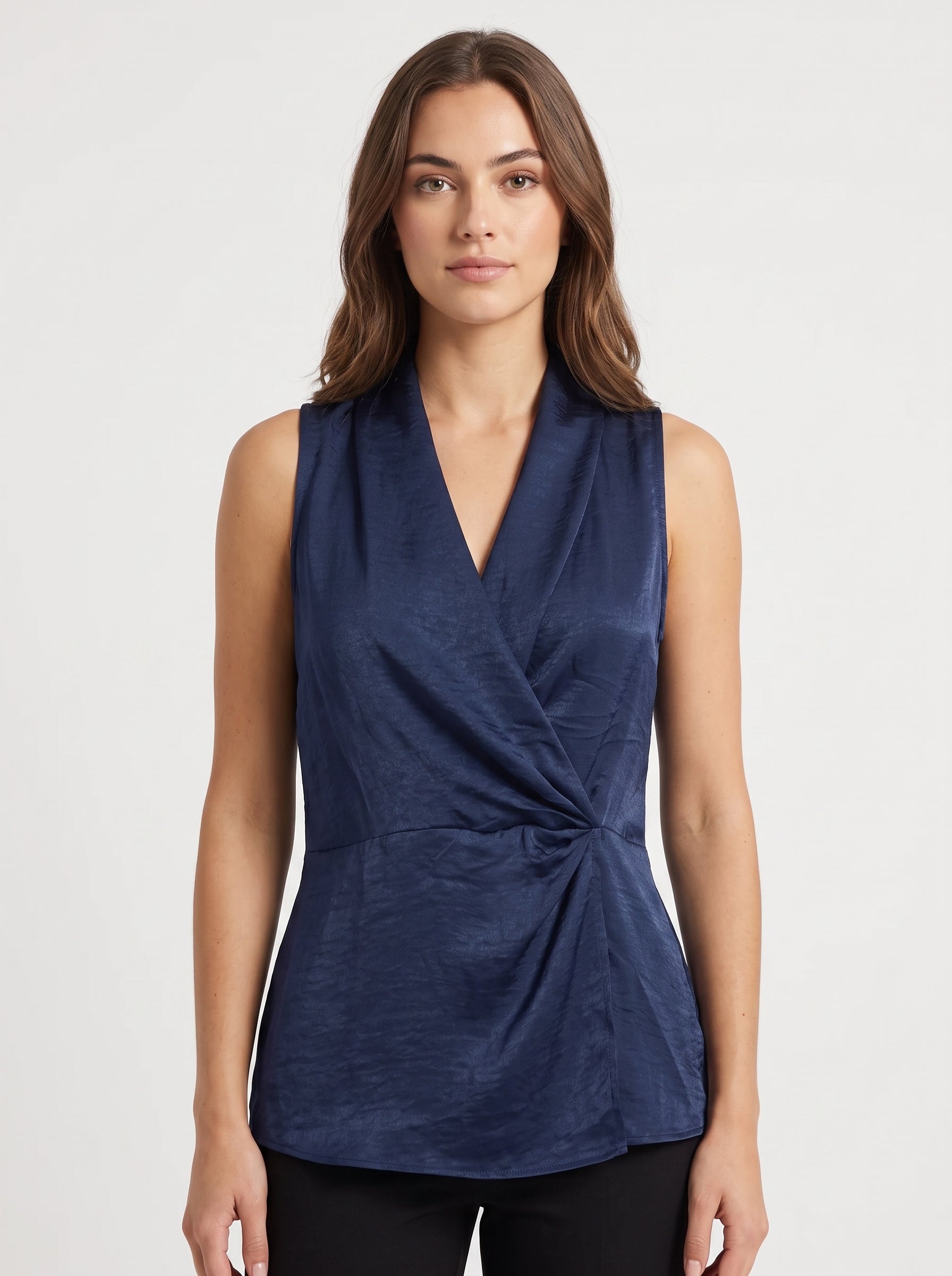 Studio photo of Blusa azul cruzada Standing facing the camera, natural confident posture, arms relaxed at sides, front view, full body visible. CAMERA SHOT: A FULL BODY shot capturing the person from head to toe. [Upper body focus]