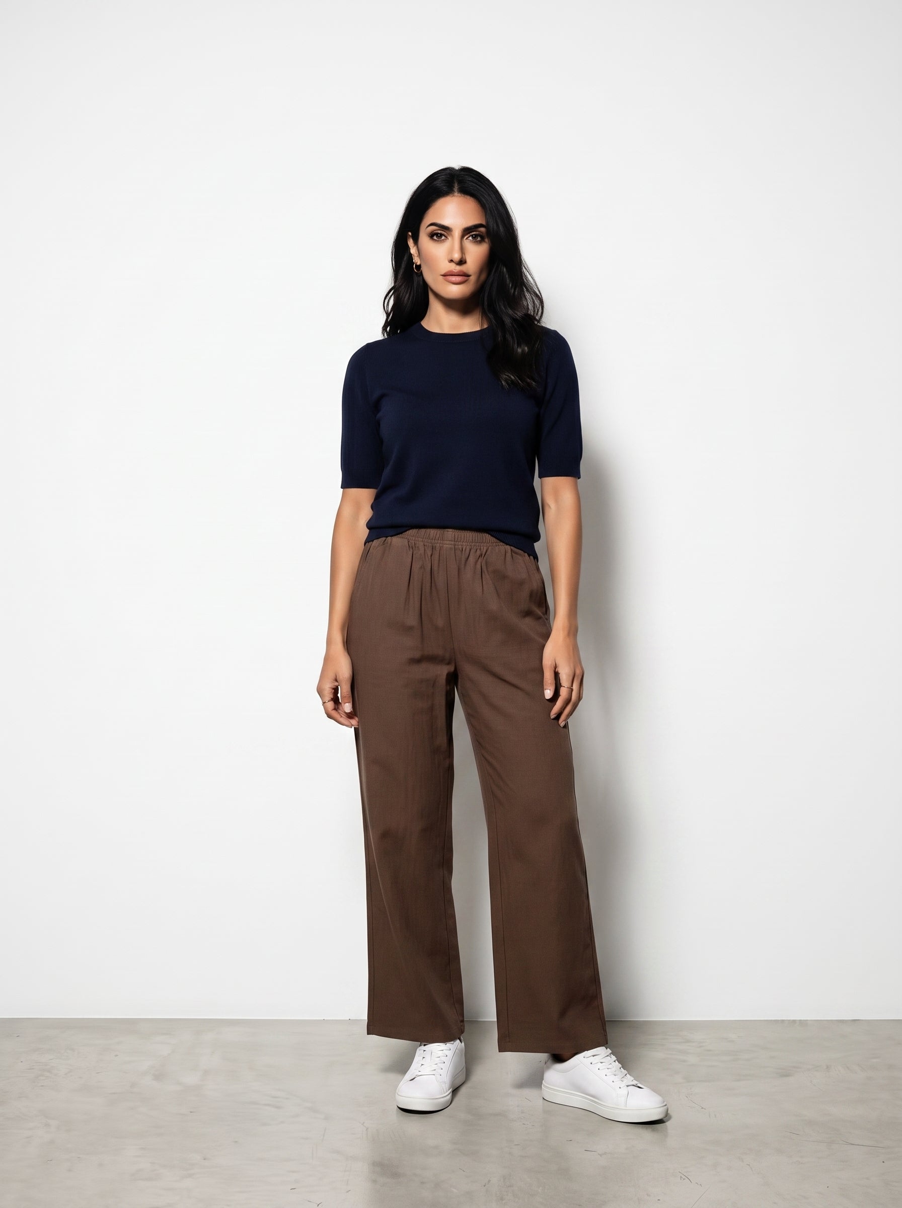 Studio photo of Pantalón cafe Lower body shot from waist down, facing camera, showing pants/skirt front, legs straight. CAMERA SHOT: A FULL BODY shot capturing the person from head to toe. [Full body]