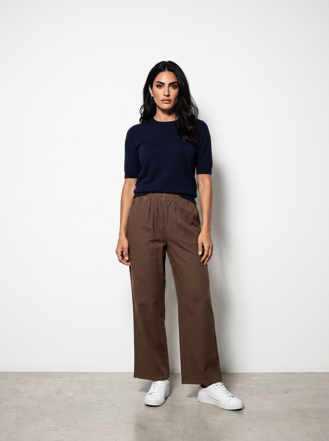 Studio photo of Pantalón cafe Lower body shot from waist down, facing camera, showing pants/skirt front, legs straight. CAMERA SHOT: A FULL BODY shot capturing the person from head to toe. [Full body]