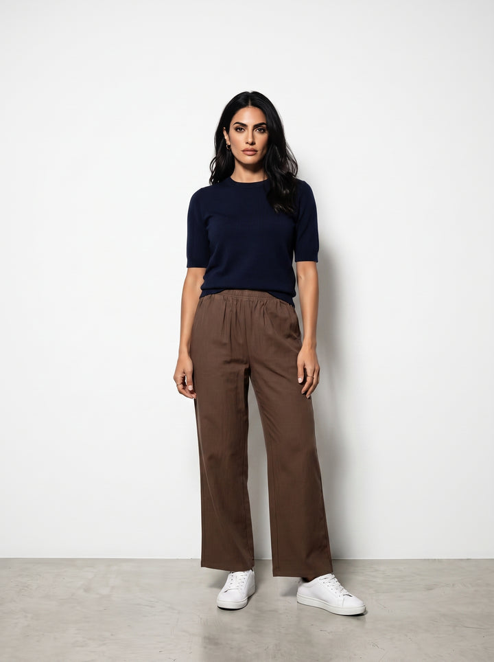 Studio photo of Pantalón cafe Lower body shot from waist down, facing camera, showing pants/skirt front, legs straight. CAMERA SHOT: A FULL BODY shot capturing the person from head to toe. [Full body]