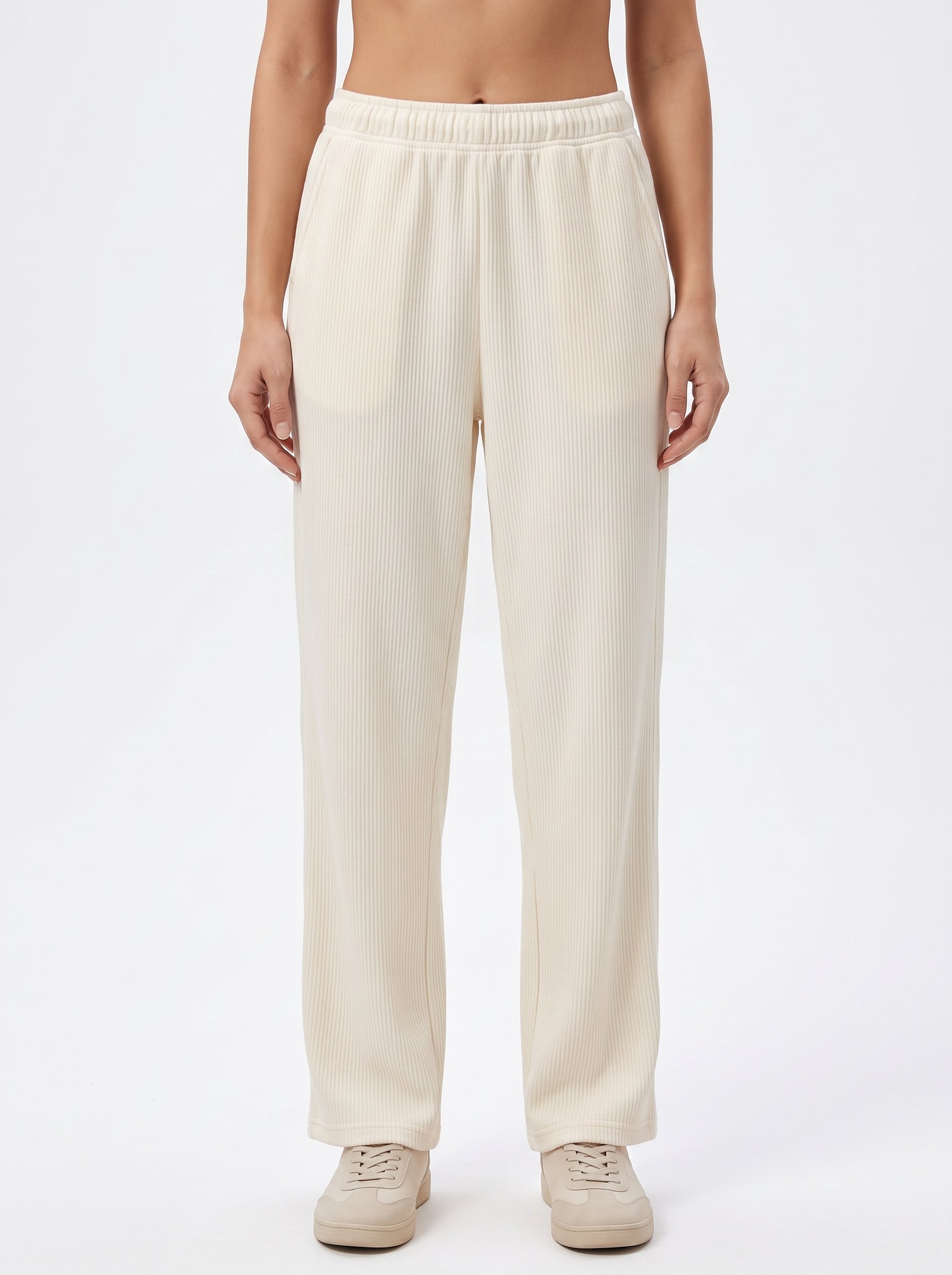 Studio photo of Pants beige Lower body shot from waist down, facing camera, showing pants/skirt front, legs straight. CAMERA SHOT: A FULL BODY shot capturing the person from head to toe. [Upper body focus]