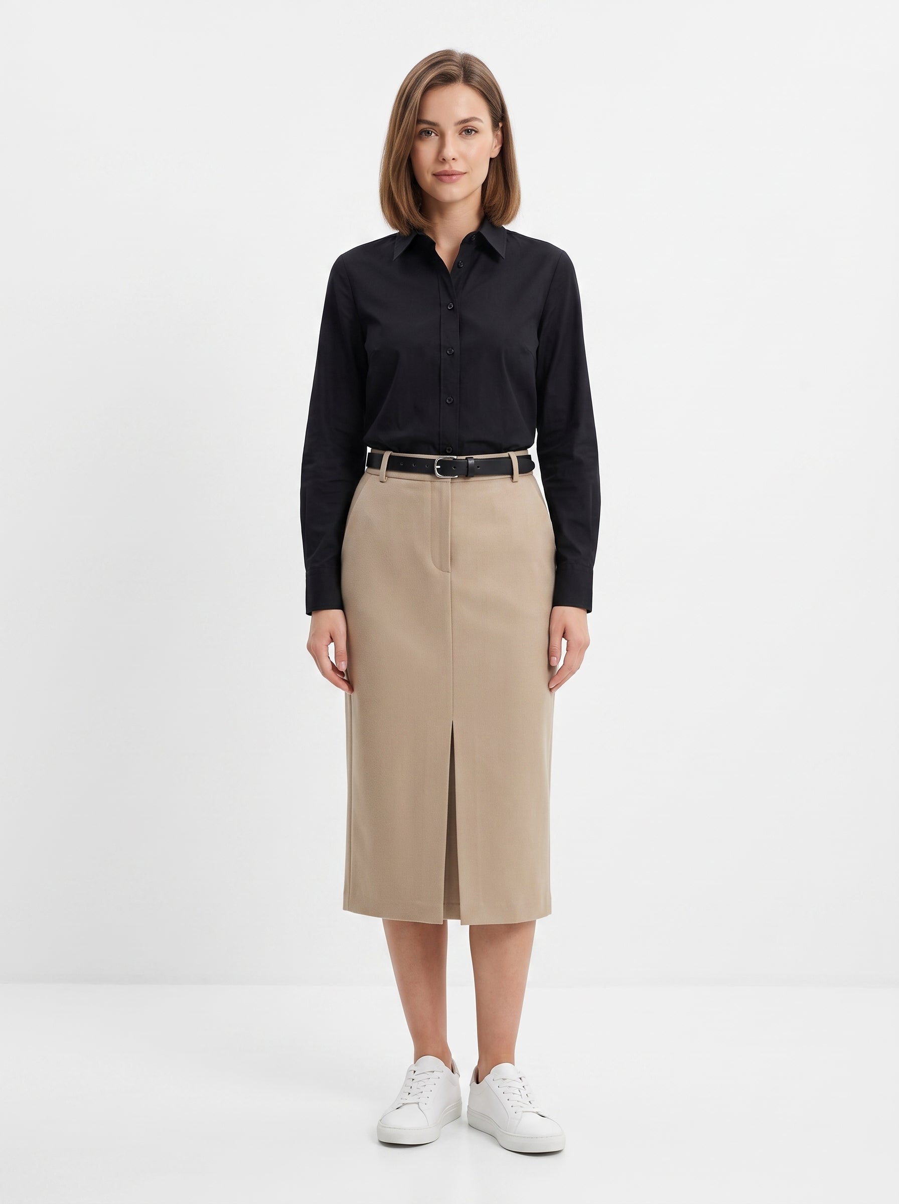 Studio photo of Falda beige Standing facing the camera, natural confident posture, arms relaxed at sides, front view, full body visible. CAMERA SHOT: A FULL BODY shot capturing the person from head to toe. [Full body]