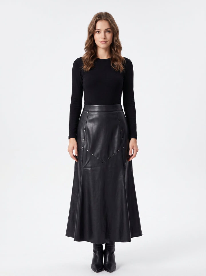 Studio photo of Falda Midi Vinipiel Negra con estoperoles Upper body shot from chest up, facing camera, natural expression, shoulders relaxed. CAMERA SHOT: A FULL BODY shot capturing the person from head to toe. [Upper body focus]