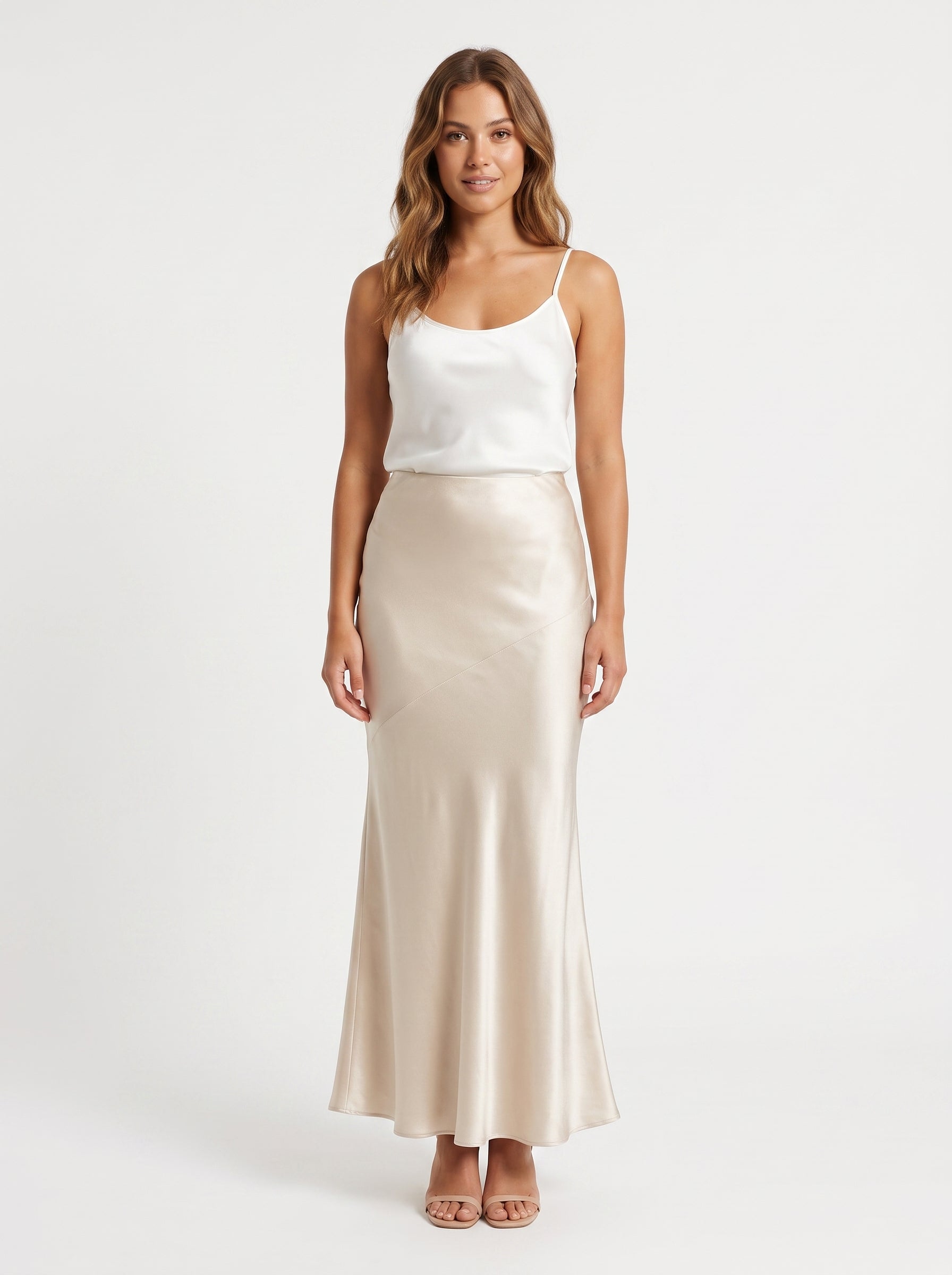 Studio photo of Falda larga satin beige Standing facing the camera, natural confident posture, arms relaxed at sides, front view, full body visible. CAMERA SHOT: A FULL BODY shot capturing the person from head to toe. [Upper body focus]