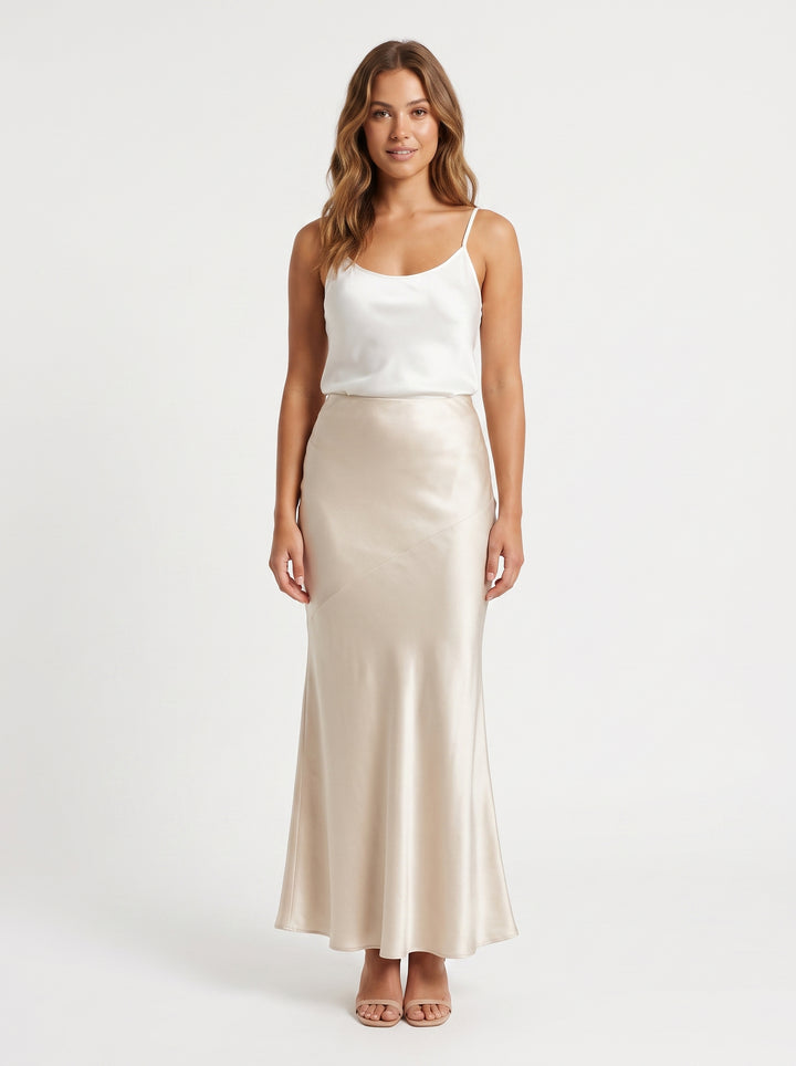 Studio photo of Falda larga satin beige Standing facing the camera, natural confident posture, arms relaxed at sides, front view, full body visible. CAMERA SHOT: A FULL BODY shot capturing the person from head to toe. [Upper body focus]