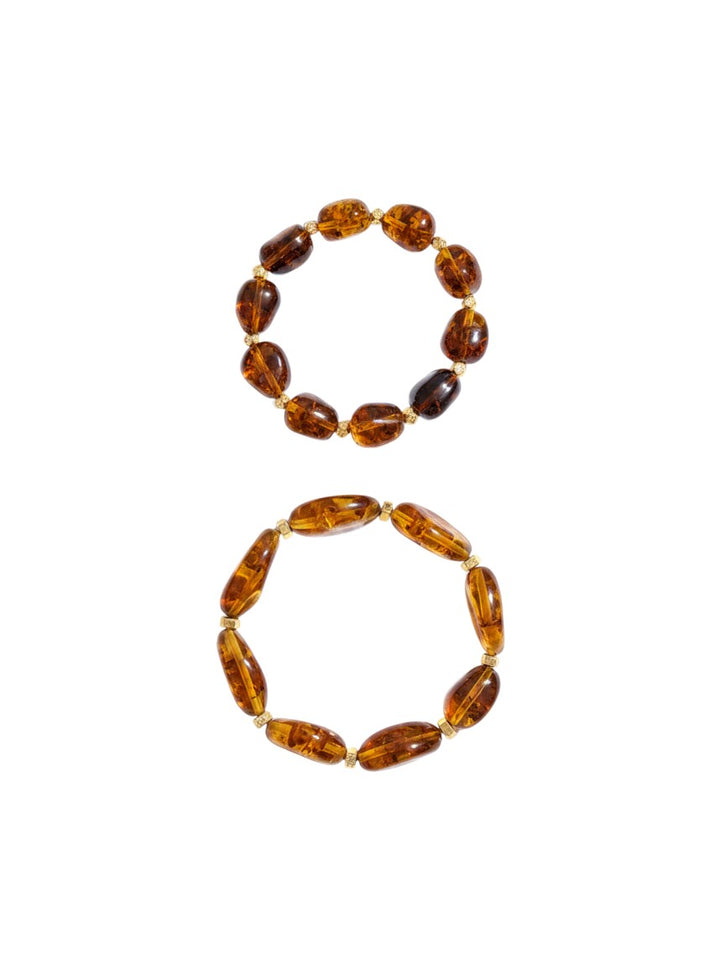Yanet Collective brown amber bead stretch bracelets with gold-tone spacers on a white background