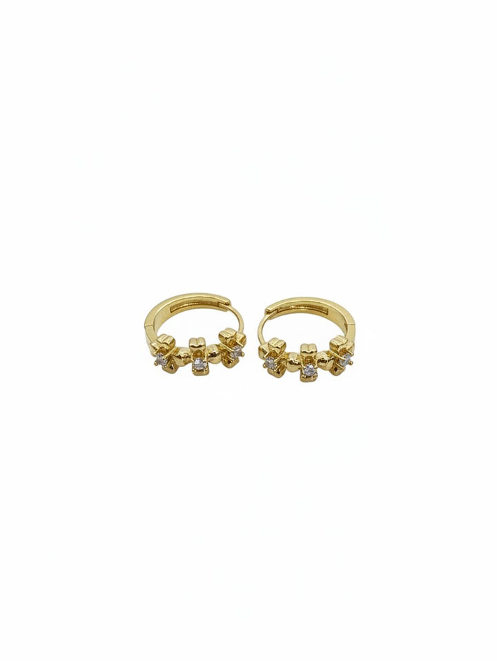 Yanet Collective gold hoop earrings featuring delicate flower-shaped charms with small sparkling clear stones