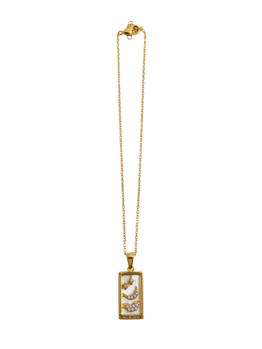Yanet Collective gold necklace featuring a rectangular tarot card pendant with moon and star crystal accents.