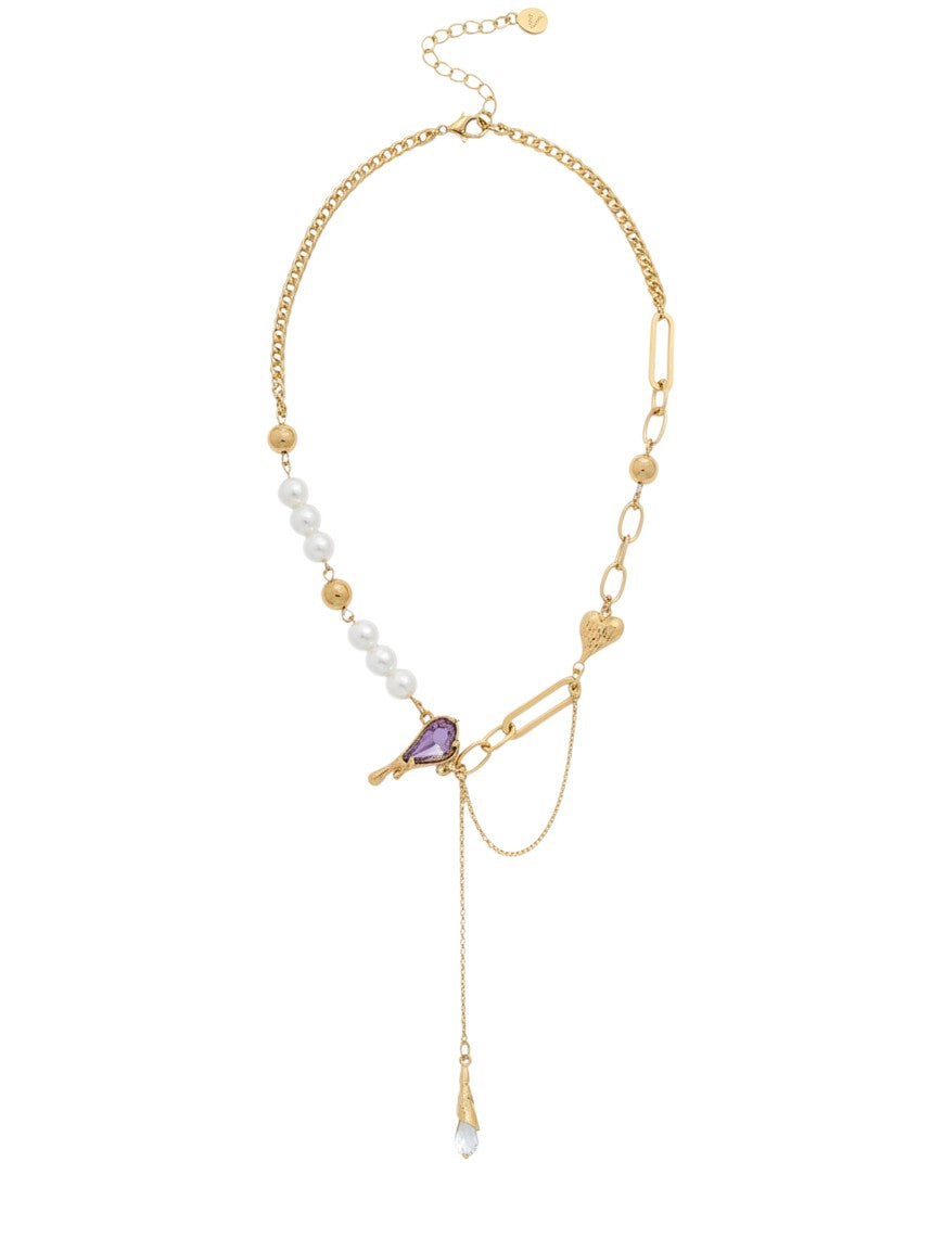 Yanet Collective gold chain necklace with white pearls, a purple heart-shaped pendant, and a delicate drop charm.