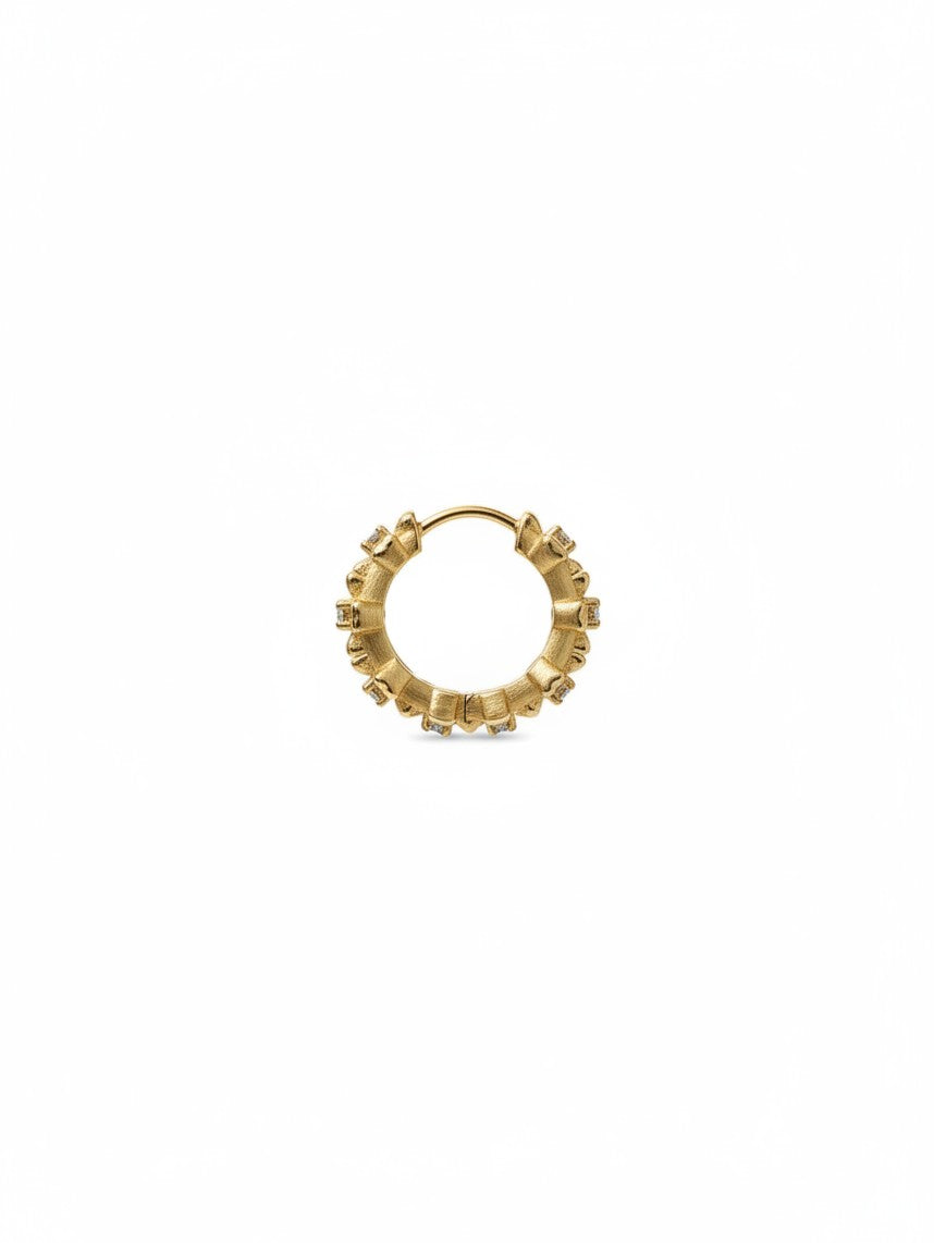 Yanet Collective gold hoop earring featuring a textured band and small embedded stones
