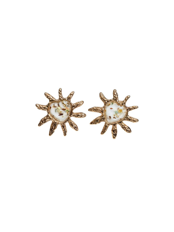 Yanet Collective heart-shaped stud earrings in beige with gold sunburst frames and textured metallic finish
