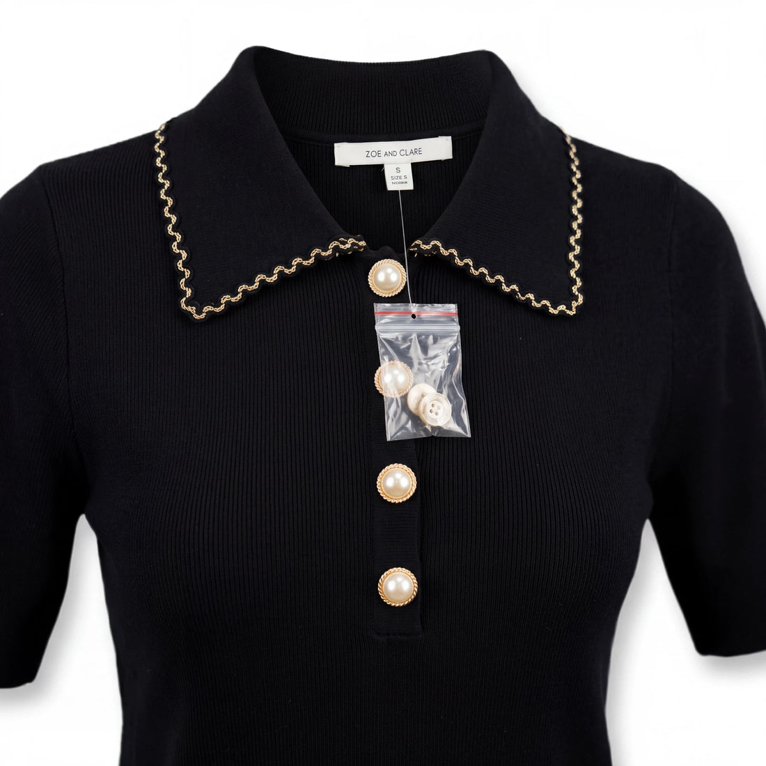 Top de punto negro Yanet Collective con cuello de solapa, ribete en contraste y botones perlados frontales